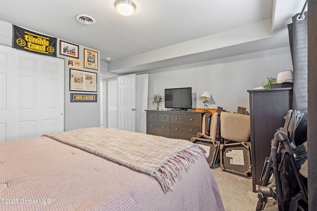 bedroom with carpet floors and visible vents