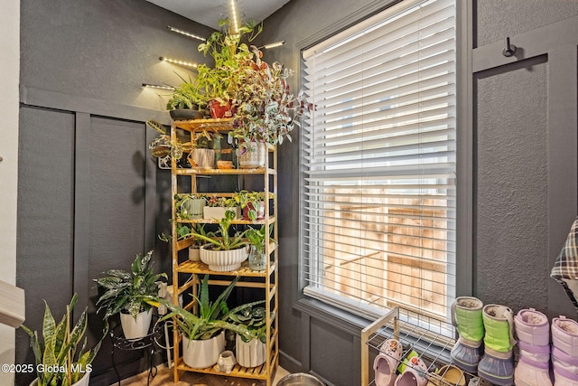 interior space with a textured wall and a healthy amount of sunlight