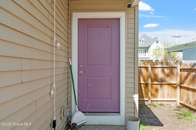 view of exterior entry with fence