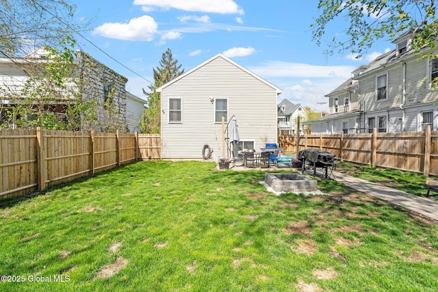 back of property featuring a patio, a fenced backyard, an outdoor fire pit, and a yard