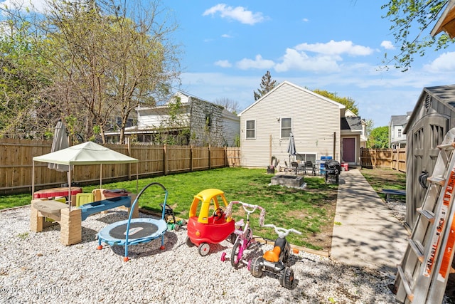 view of yard featuring a fenced backyard, a fire pit, and a patio area