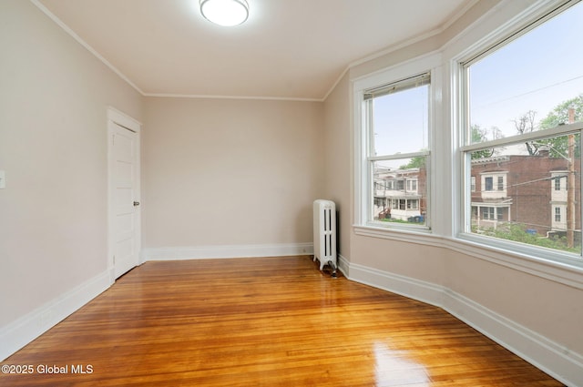 18 Bertha St, Albany, NY 12209 - empty room featuring radiator, crown molding, light wood-type flooring, and baseboards