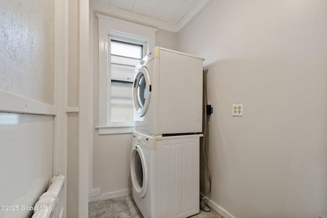 18 Bertha St, Albany, NY 12209 - laundry area with stacked washer / dryer, crown molding, baseboards, and laundry area