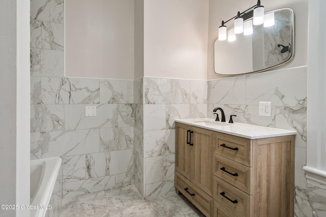18 Bertha St, Albany, NY 12209 - full bath with tile walls, marble finish floor, vanity, and a tub to relax in