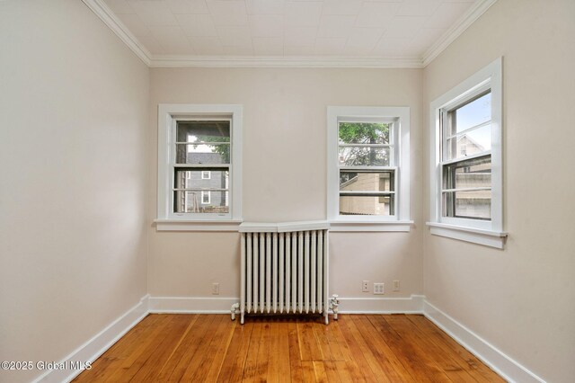 18 Bertha St, Albany, NY 12209 - empty room with radiator, hardwood / wood-style floors, and crown molding