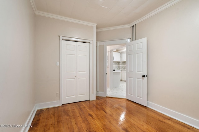 18 Bertha St, Albany, NY 12209 - unfurnished bedroom featuring light wood finished floors, crown molding, and baseboards