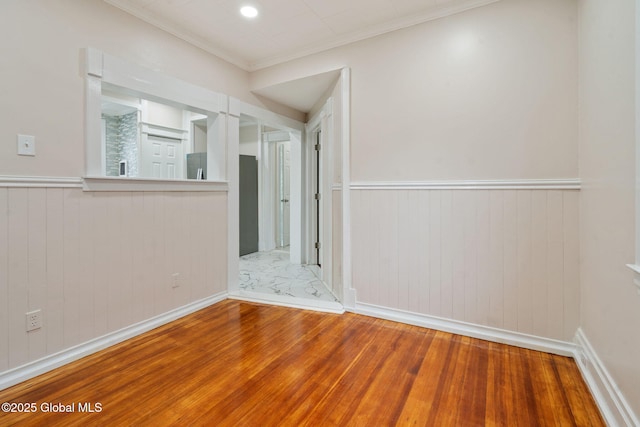 18 Bertha St, Albany, NY 12209 - empty room with ornamental molding, wood walls, wainscoting, and wood finished floors