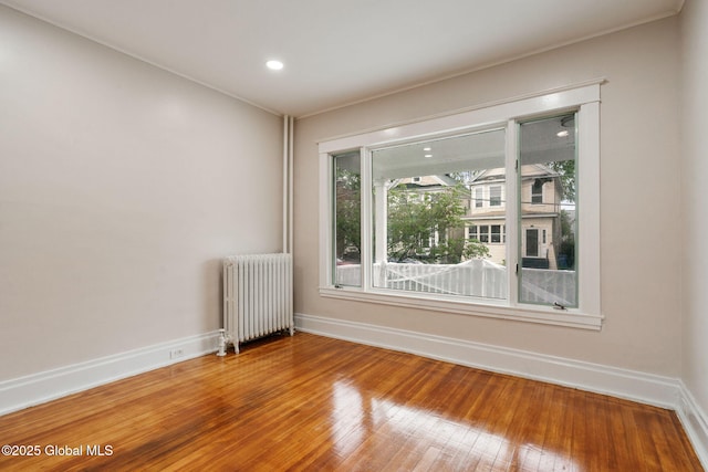 18 Bertha St, Albany, NY 12209 - unfurnished room featuring recessed lighting, wood-type flooring, baseboards, and radiator heating unit
