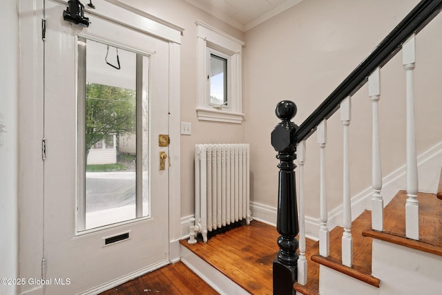 18 Bertha St, Albany, NY 12209 - foyer featuring stairway, radiator heating unit, crown molding, and dark wood-type flooring