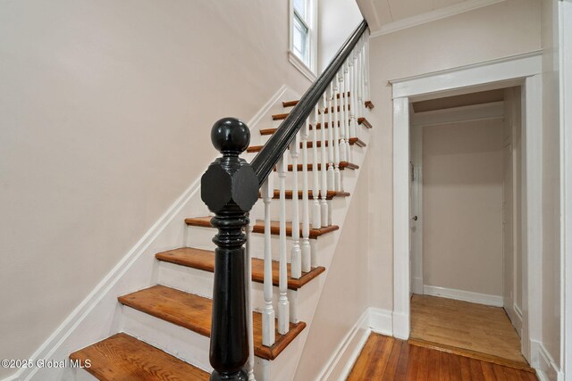18 Bertha St, Albany, NY 12209 - stairway featuring crown molding, baseboards, and wood finished floors