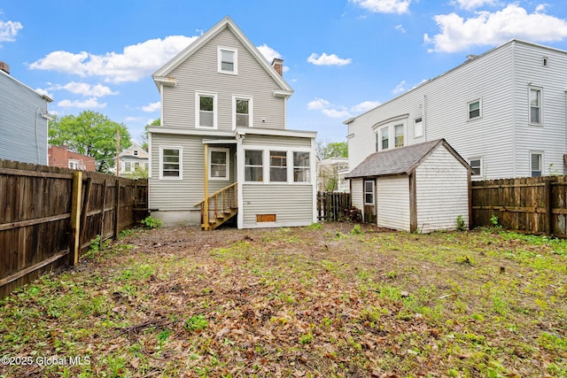 18 Bertha St, Albany, NY 12209 - back of property featuring a storage shed, a chimney, an outdoor structure, a fenced backyard, and entry steps