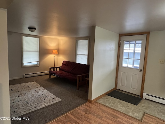 entryway with baseboards, a baseboard radiator, and wood finished floors