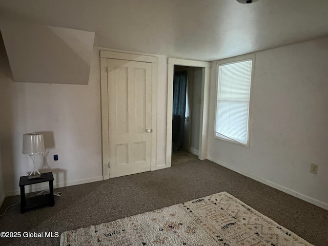 unfurnished bedroom with baseboards and carpet flooring