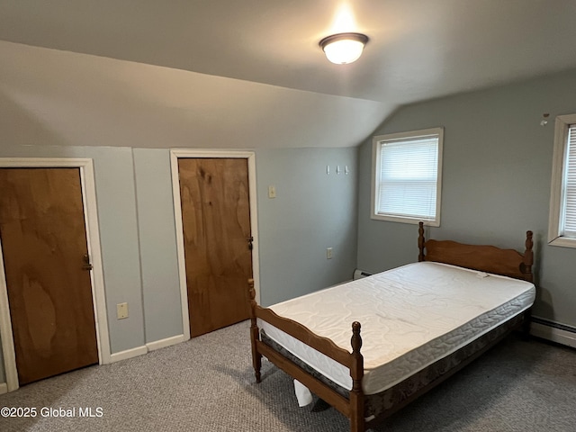 bedroom featuring baseboards, a baseboard heating unit, lofted ceiling, and light carpet