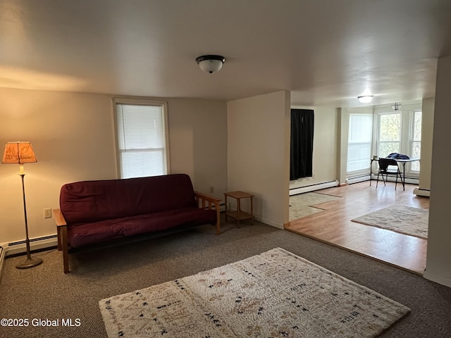 living area with baseboards, baseboard heating, and carpet