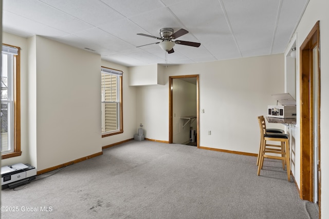 100 3rd St, Waterford, NY 12188 - unfurnished living room featuring carpet floors, a ceiling fan, and baseboards