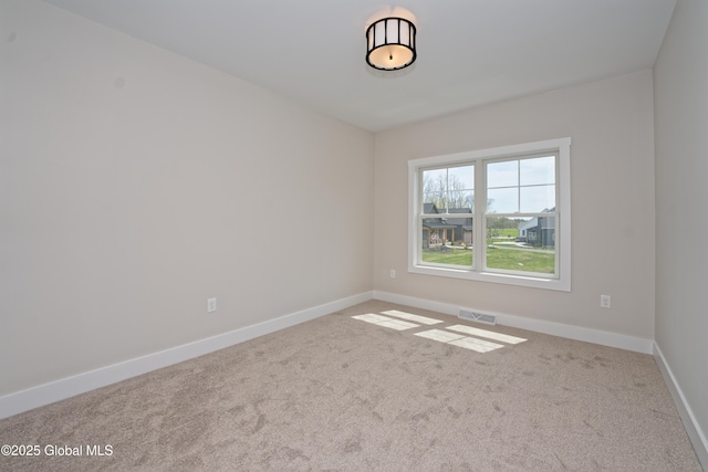unfurnished room featuring carpet floors, baseboards, and visible vents