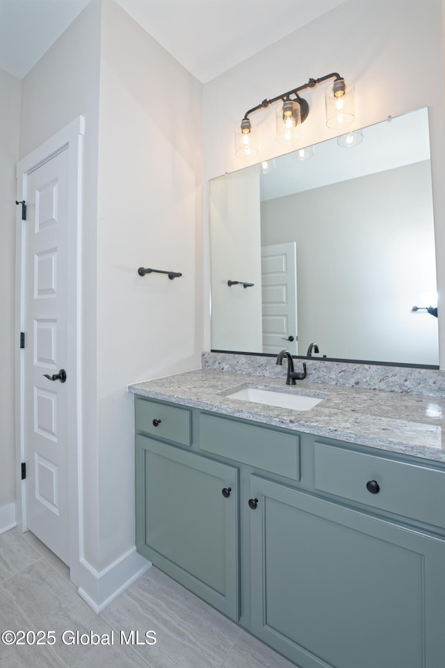 bathroom with vanity and baseboards