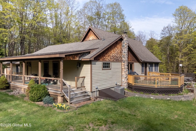 3550 Boyhaven Rd, Middle Grove, NY 12850 - rear view of house with a lawn, a deck, a shingled roof, and a chimney