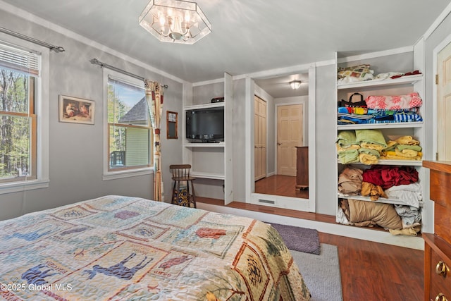 3550 Boyhaven Rd, Middle Grove, NY 12850 - bedroom featuring crown molding, visible vents, wood finished floors, and an inviting chandelier