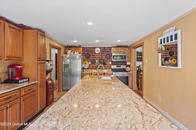 3550 Boyhaven Rd, Middle Grove, NY 12850 - kitchen featuring backsplash, appliances with stainless steel finishes, brown cabinets, a sink, and light stone counters