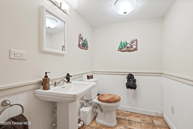 3550 Boyhaven Rd, Middle Grove, NY 12850 - half bathroom featuring stone finish floor, wainscoting, and toilet