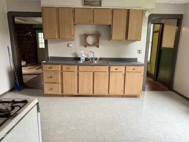 6 Cline St, Dolgeville, NY 13329 - kitchen with a sink, dark countertops, baseboards, and light tile patterned flooring