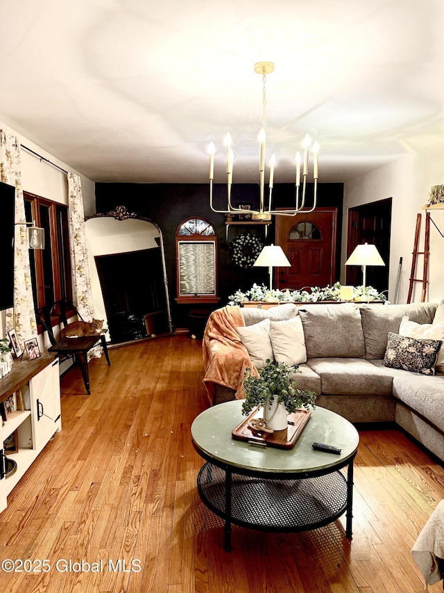 living room featuring an inviting chandelier and hardwood / wood-style flooring