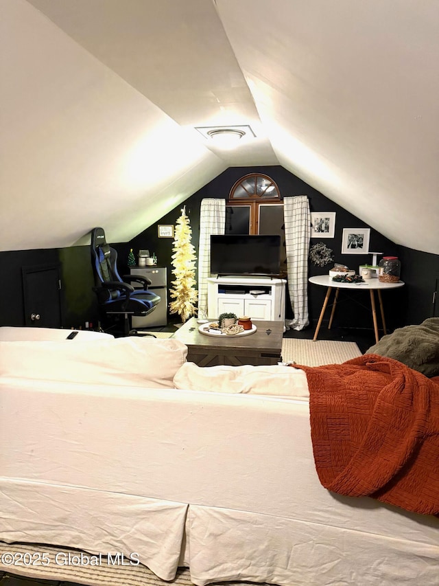 bedroom with visible vents and vaulted ceiling
