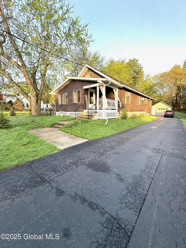 view of front of home with a porch and a front yard