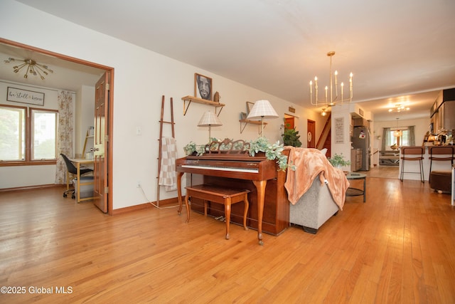 975 Riverview Rd, Schenectady, NY 12309 - living area with a chandelier, light wood-style flooring, and baseboards