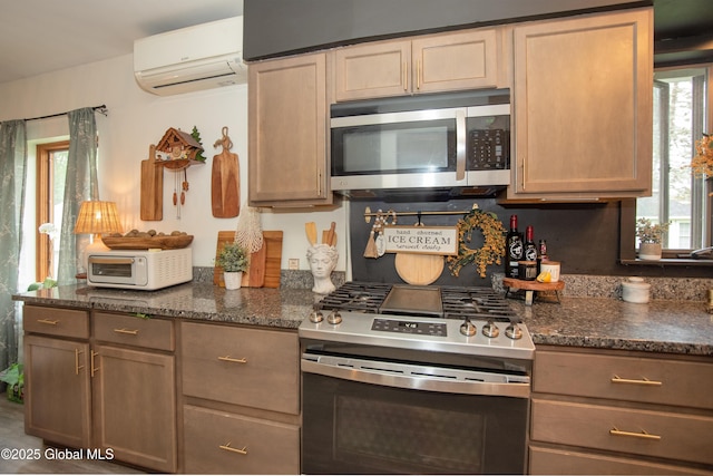 975 Riverview Rd, Schenectady, NY 12309 - kitchen with stainless steel appliances, a wall mounted AC, and dark stone counters