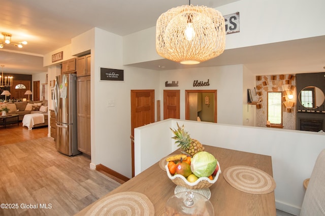 975 Riverview Rd, Schenectady, NY 12309 - dining room with a chandelier, light wood-style floors, and baseboards