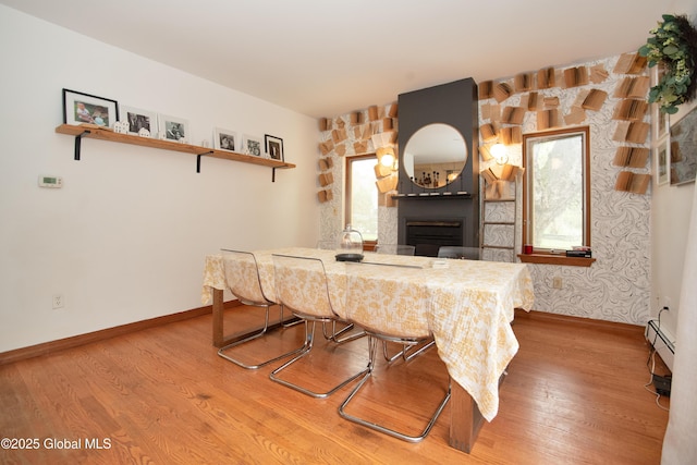 975 Riverview Rd, Schenectady, NY 12309 - dining space with wood finished floors, baseboards, a fireplace, and baseboard heating