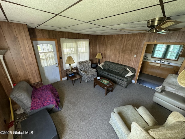 113 Forest Ave, Caroga, NY 12032 - living area with a paneled ceiling, a ceiling fan, wood walls, and a wealth of natural light
