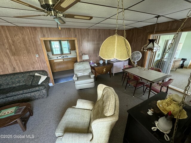 113 Forest Ave, Caroga, NY 12032 - living area with carpet flooring, wooden walls, and a ceiling fan