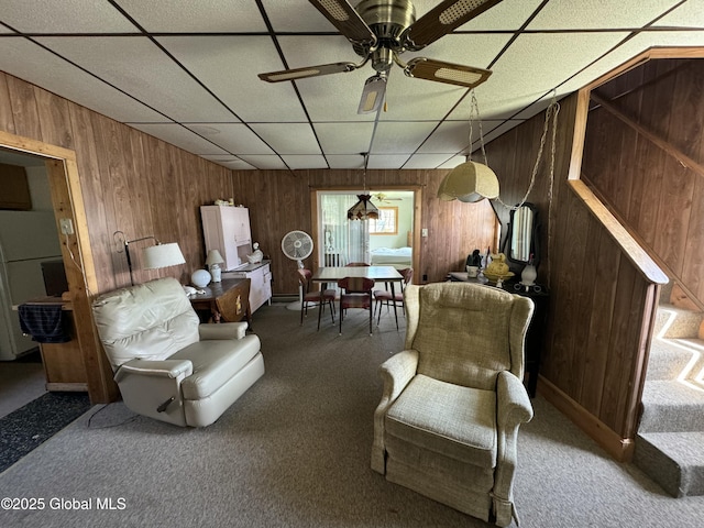 113 Forest Ave, Caroga, NY 12032 - living area featuring wood walls, a ceiling fan, a drop ceiling, and carpet flooring