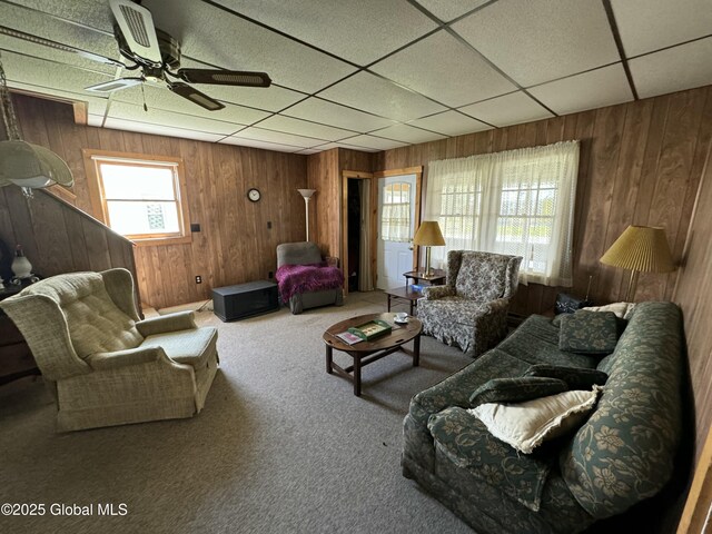 113 Forest Ave, Caroga, NY 12032 - living area featuring ceiling fan, carpet, wood walls, and a paneled ceiling