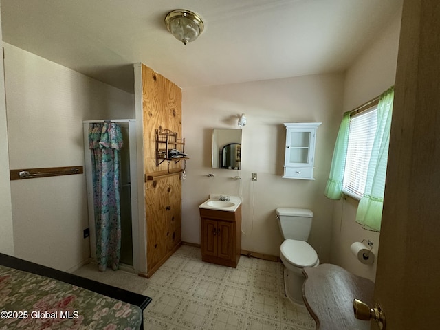 113 Forest Ave, Caroga, NY 12032 - bathroom with curtained shower, tile patterned floors, baseboards, vanity, and toilet