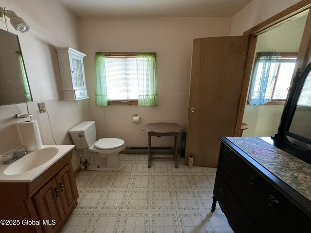 113 Forest Ave, Caroga, NY 12032 - bathroom with vanity, a baseboard radiator, and toilet