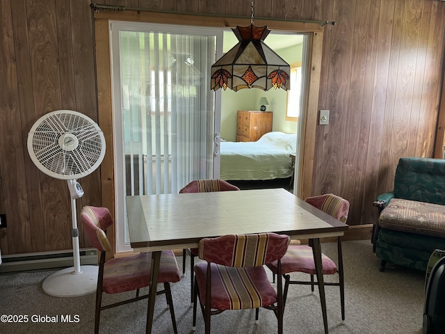 113 Forest Ave, Caroga, NY 12032 - carpeted dining area with wooden walls and a healthy amount of sunlight