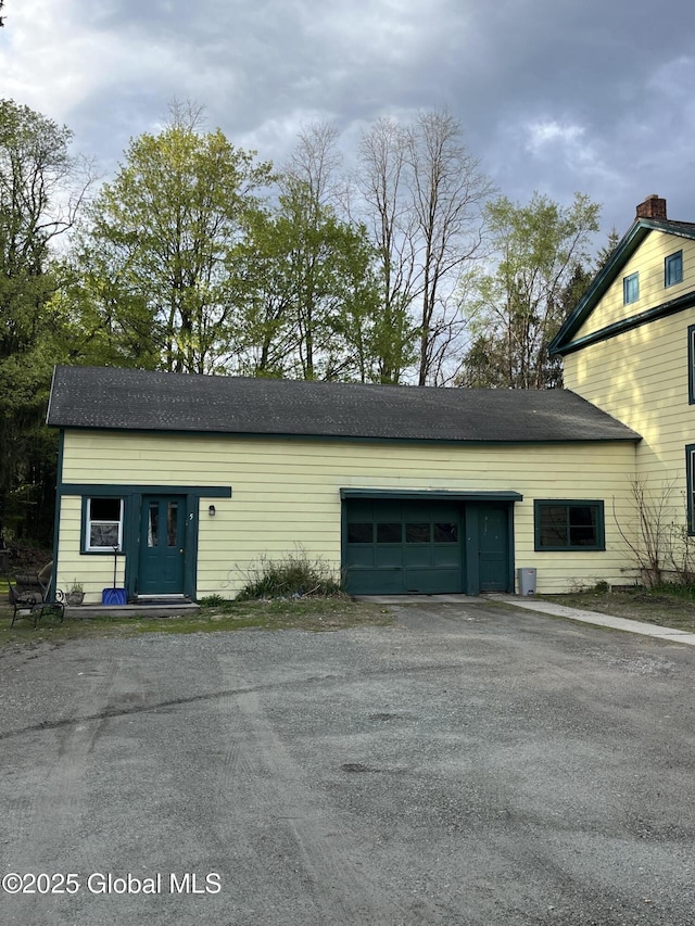 garage featuring aphalt driveway