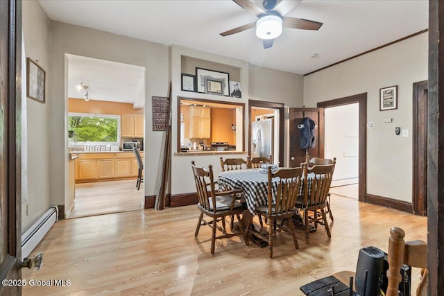 209 Lake Ave, Lake Luzerne, NY 12846 - dining space featuring baseboard heating, light wood finished floors, a ceiling fan, and baseboards