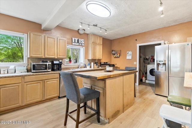 209 Lake Ave, Lake Luzerne, NY 12846 - kitchen featuring washer / clothes dryer, stainless steel appliances, light brown cabinets, butcher block counters, and a textured ceiling
