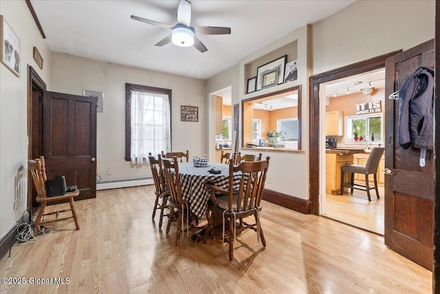 209 Lake Ave, Lake Luzerne, NY 12846 - dining area with baseboard heating, light wood-style floors, a ceiling fan, and baseboards