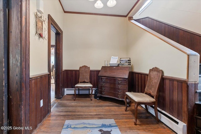 209 Lake Ave, Lake Luzerne, NY 12846 - living area featuring wainscoting, baseboard heating, crown molding, wood finished floors, and wood walls