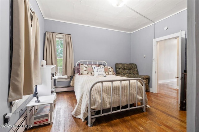 209 Lake Ave, Lake Luzerne, NY 12846 - bedroom featuring baseboard heating and hardwood / wood-style floors