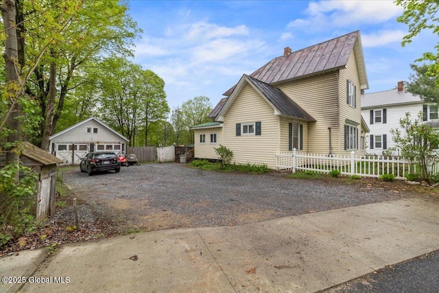 209 Lake Ave, Lake Luzerne, NY 12846 - view of side of property featuring metal roof, a standing seam roof, a chimney, fence, and an outbuilding