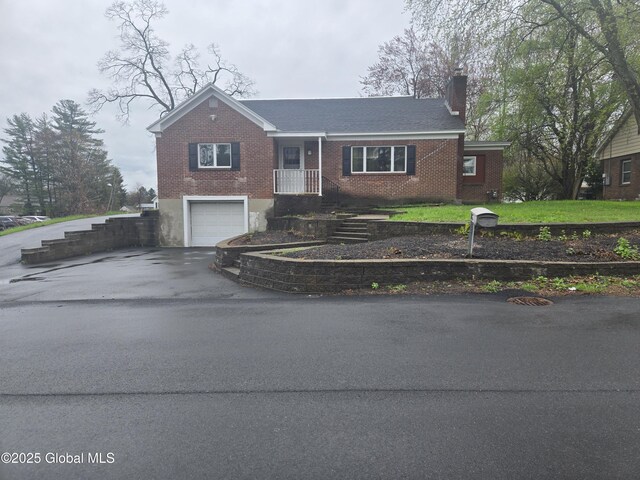 16 Van Heusen St, Colonie, NY 12205 - ranch-style house featuring driveway, brick siding, a chimney, and a garage