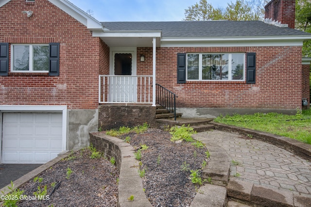 16 Van Heusen St, Colonie, NY 12205 - view of front of property featuring brick siding, a chimney, an attached garage, and roof with shingles